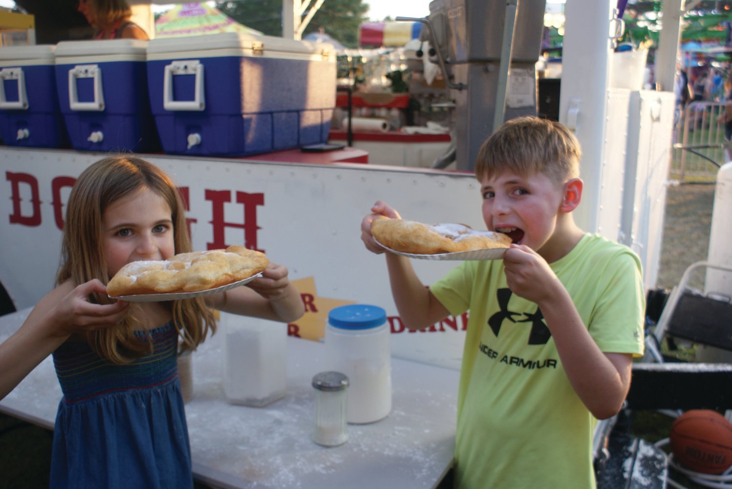 DOUGH KIDS: Enjoying dough boys in the amusement area of the St. Mary’s Feast were Macy Casale, 7, and her brother Marco, 10. 